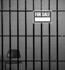 Empty jail cell with for sale sign
