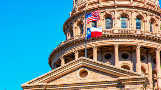 The Texas Capitol dome against a blue sky