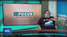 Video screengrab of Maggie speaking to a reporter, with InFocus logo behind her