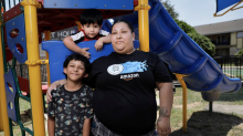 Victoria Halstead with two of her children, Jovani, 8, and Ismael, 3, on June 22 at the apartment complex playground where her 17-year-old son, Mark Halstead used to play as a child. (Tom Fox / Staff Photographer)